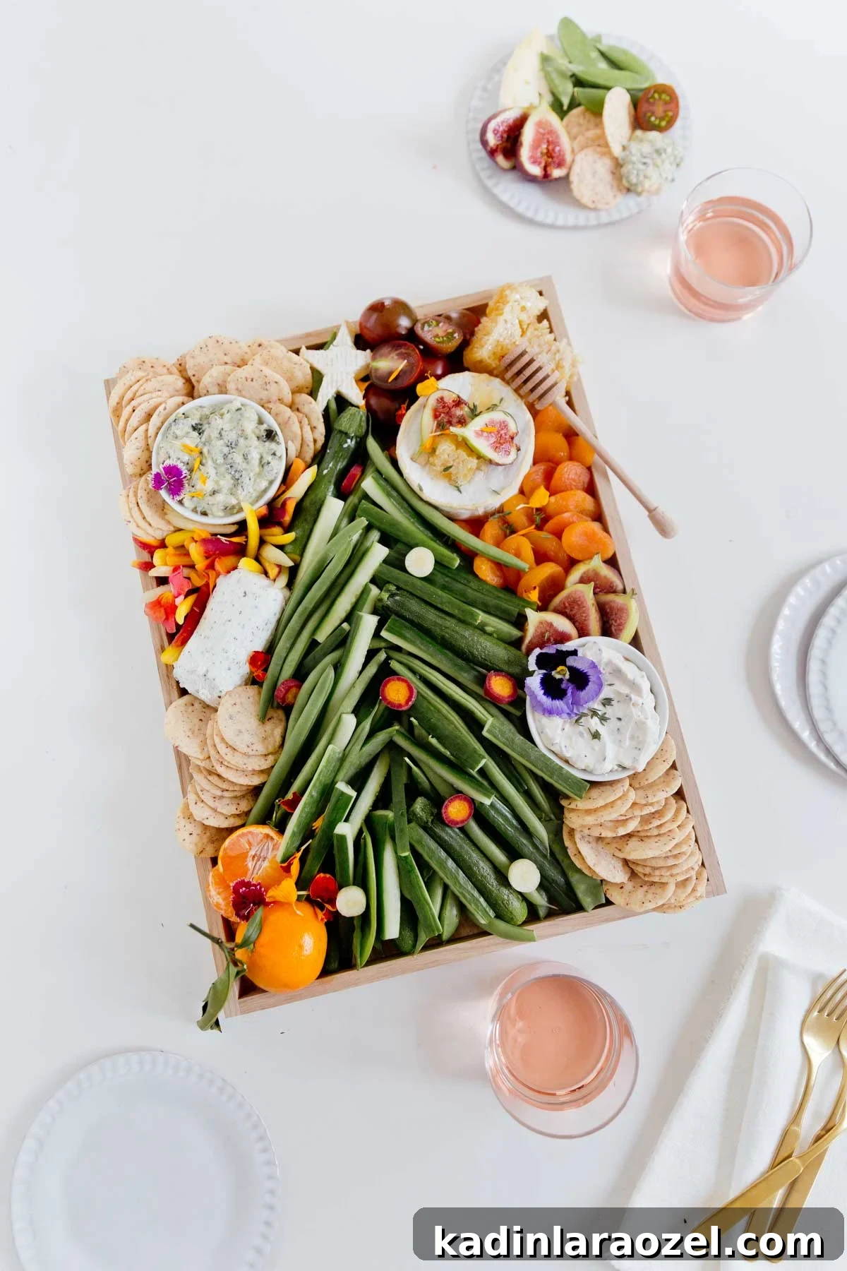 Festive Christmas Charcuterie Board Ideas for Holiday Entertaining 2 Charcuterie board with vegetables shaped like a Christmas tree, on a white table