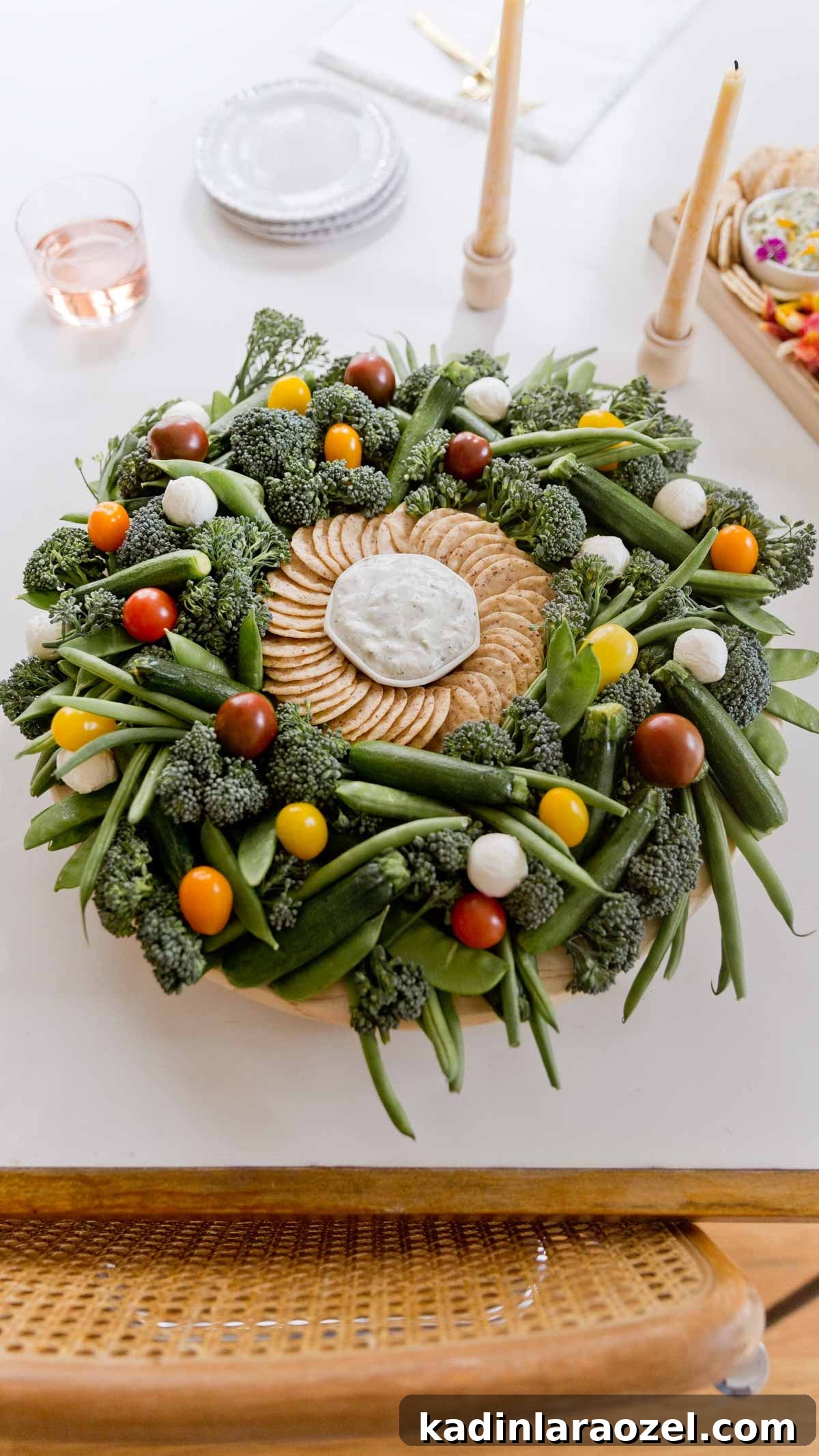 Festive Christmas Charcuterie Board Ideas for Holiday Entertaining 6 Christmas wreath shaped charcuterie board on a lazy susan with green vegetables