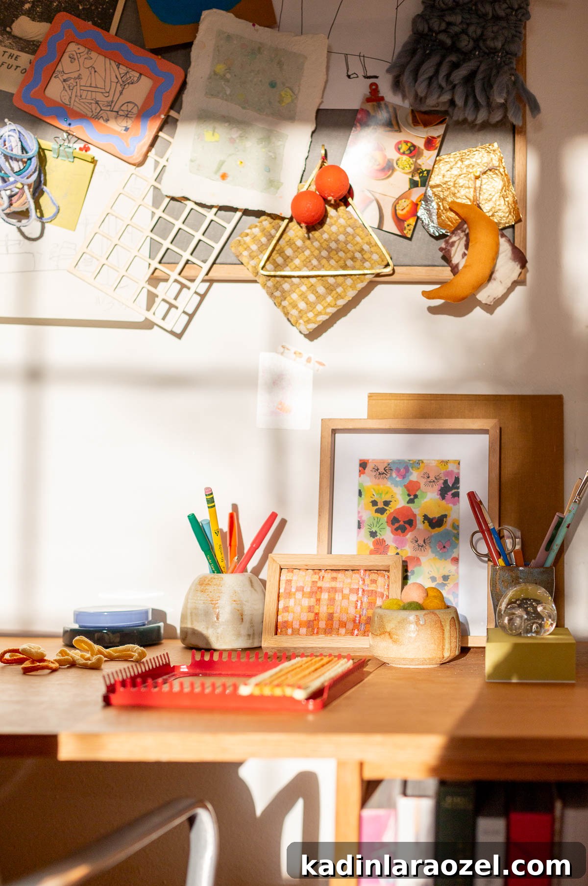 crafting space with desk and bulletin board in wood and colorful accessories