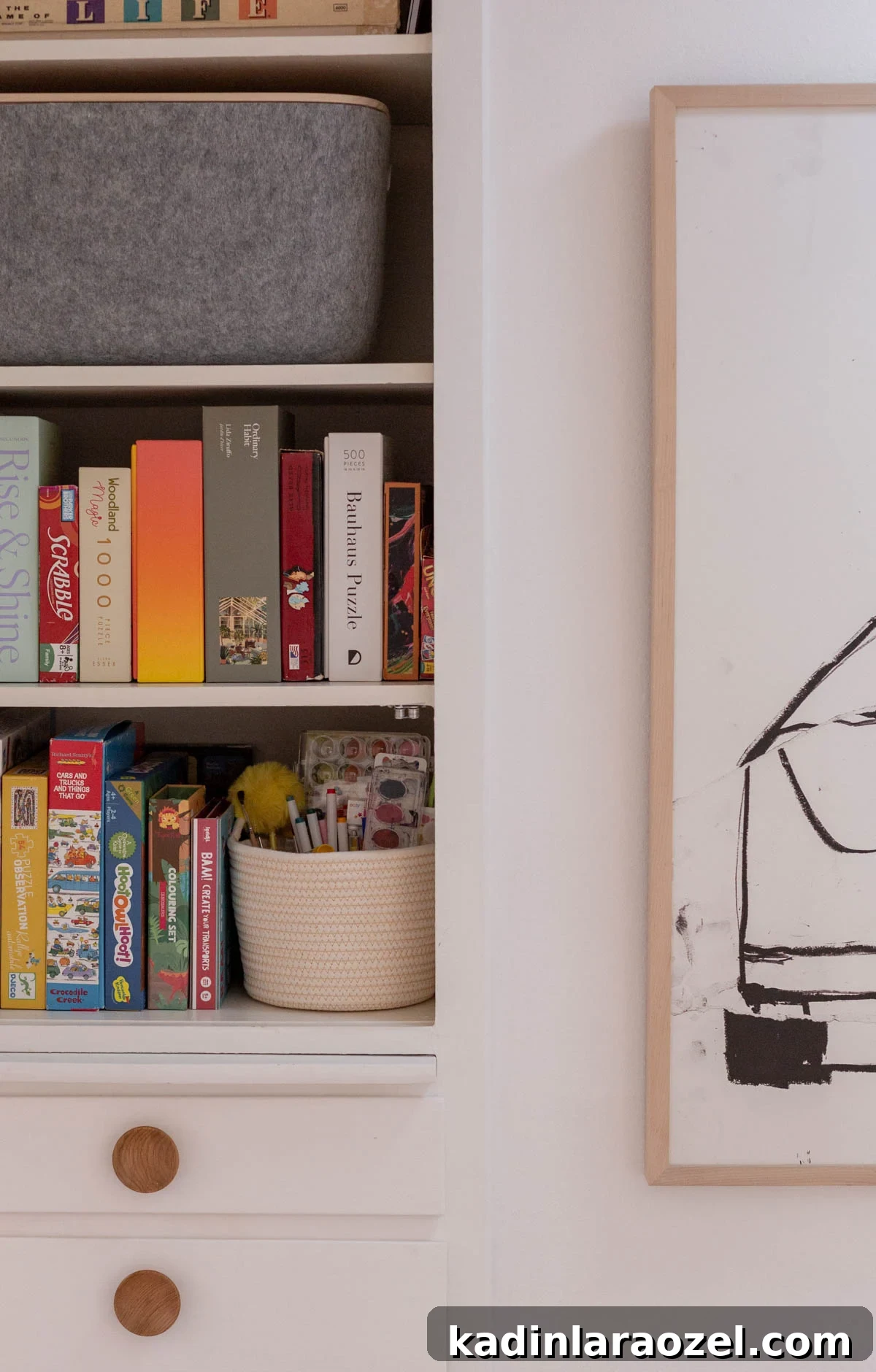 open hall closet in organic modern minimal home, lined with board games, puzzles, craft supplies, and felt bins