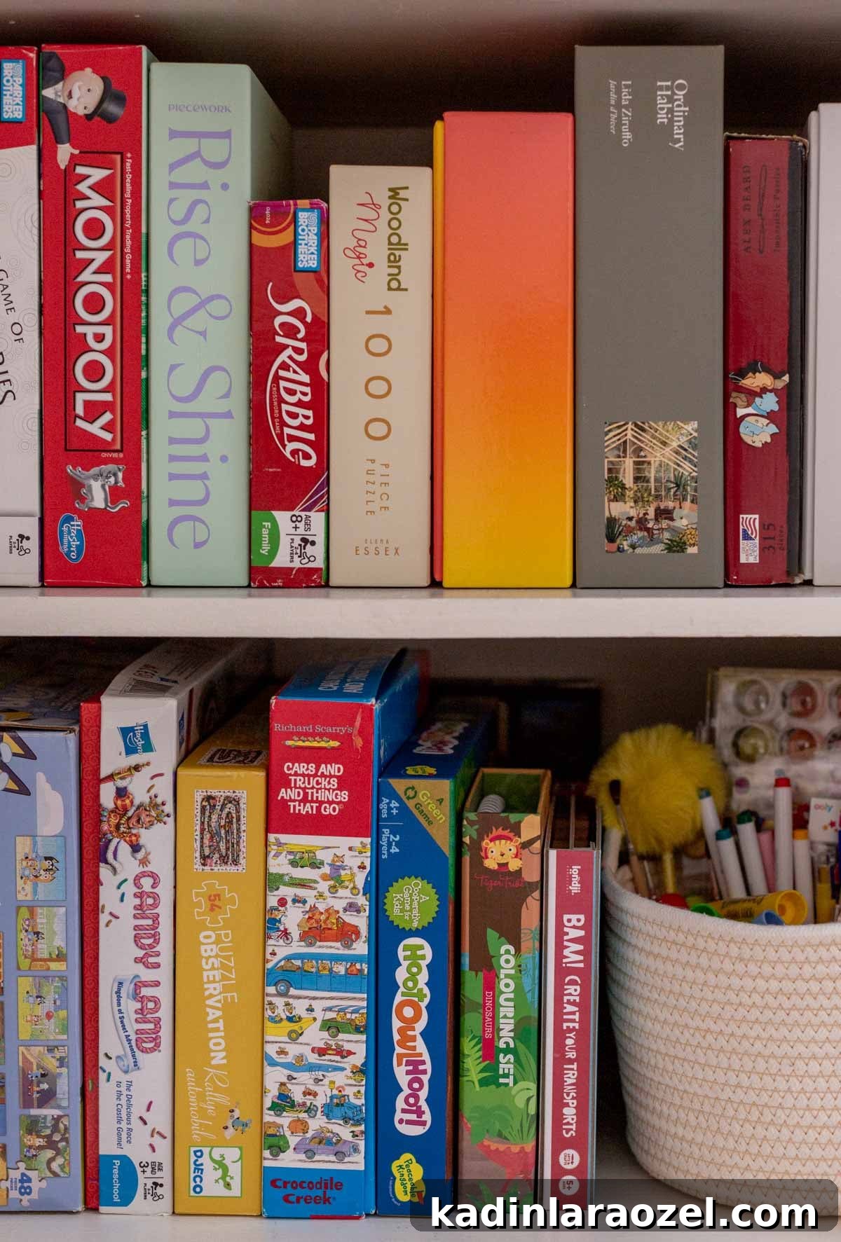 Board games and puzzles lined up on open shelving in a small hall closet