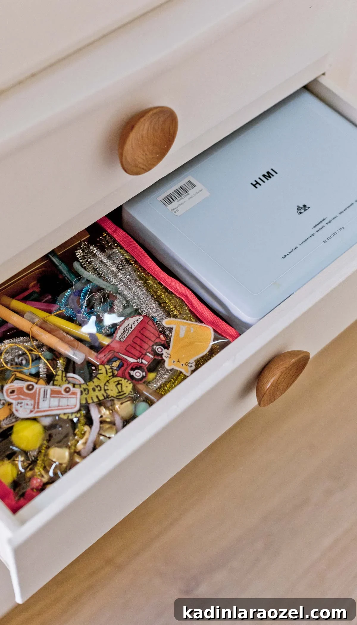 Open closet drawer with kids craft supplies organized inside