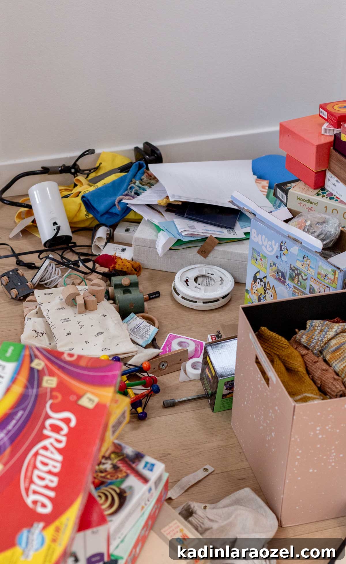 hall closet items piled up and scattered all over hardwood floor