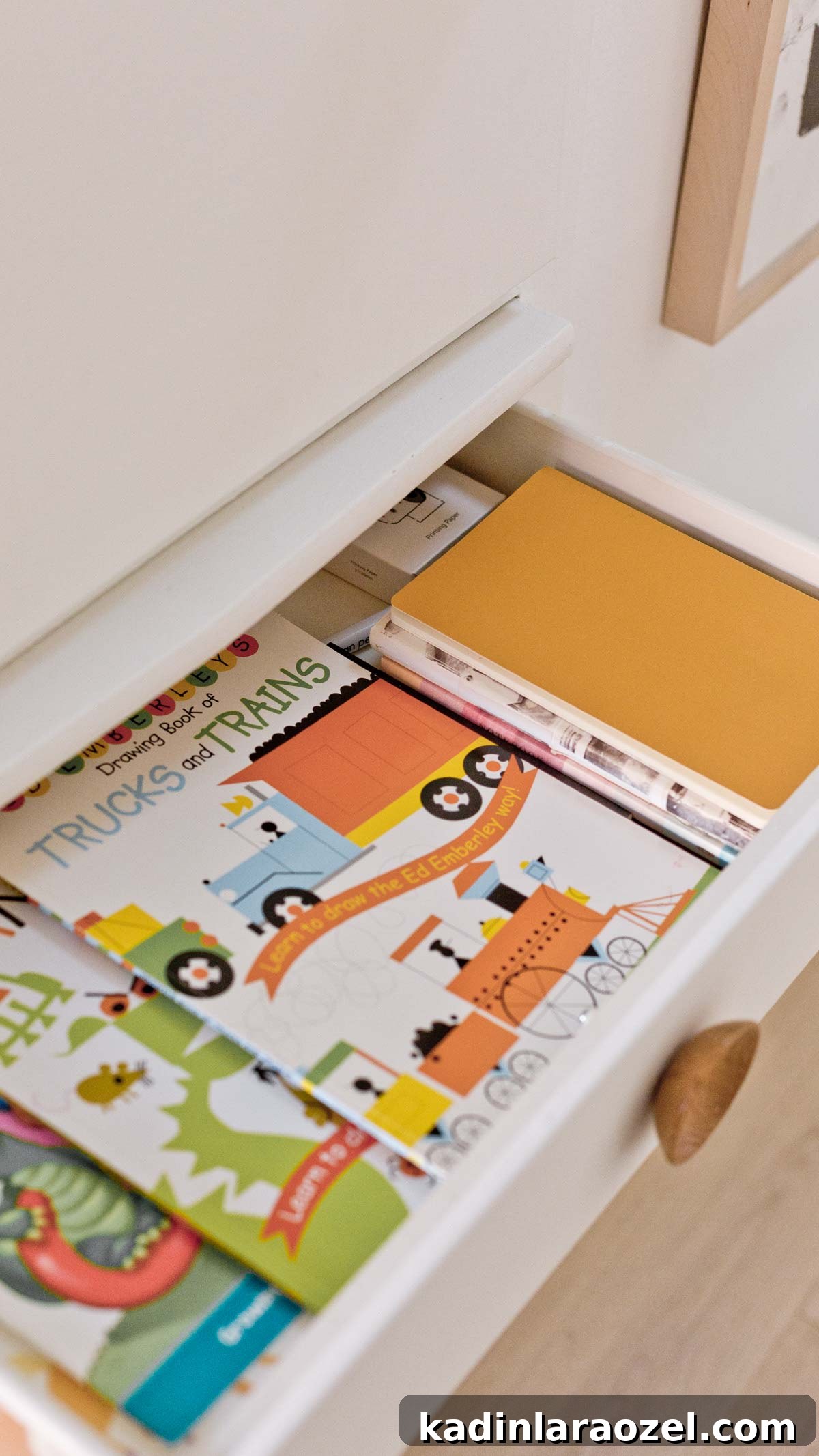 Minimal modern hall closet drawer open, showing kids craft materials organized inside
