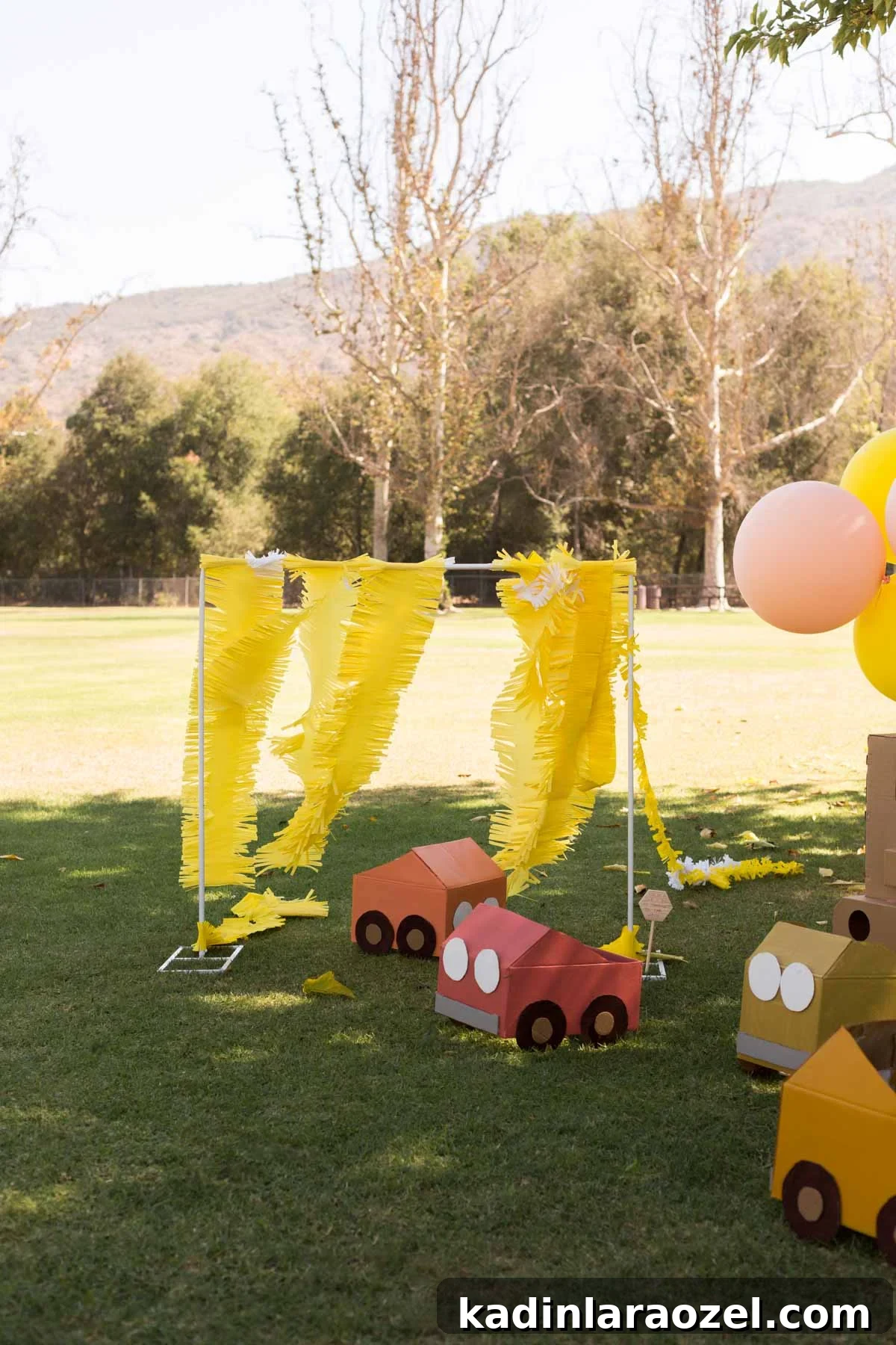Construction and Car-Themed Birthday Party Ideas for Kids 10 Colorful cardboard cars spread out on the grass at a park during a kids birthday party