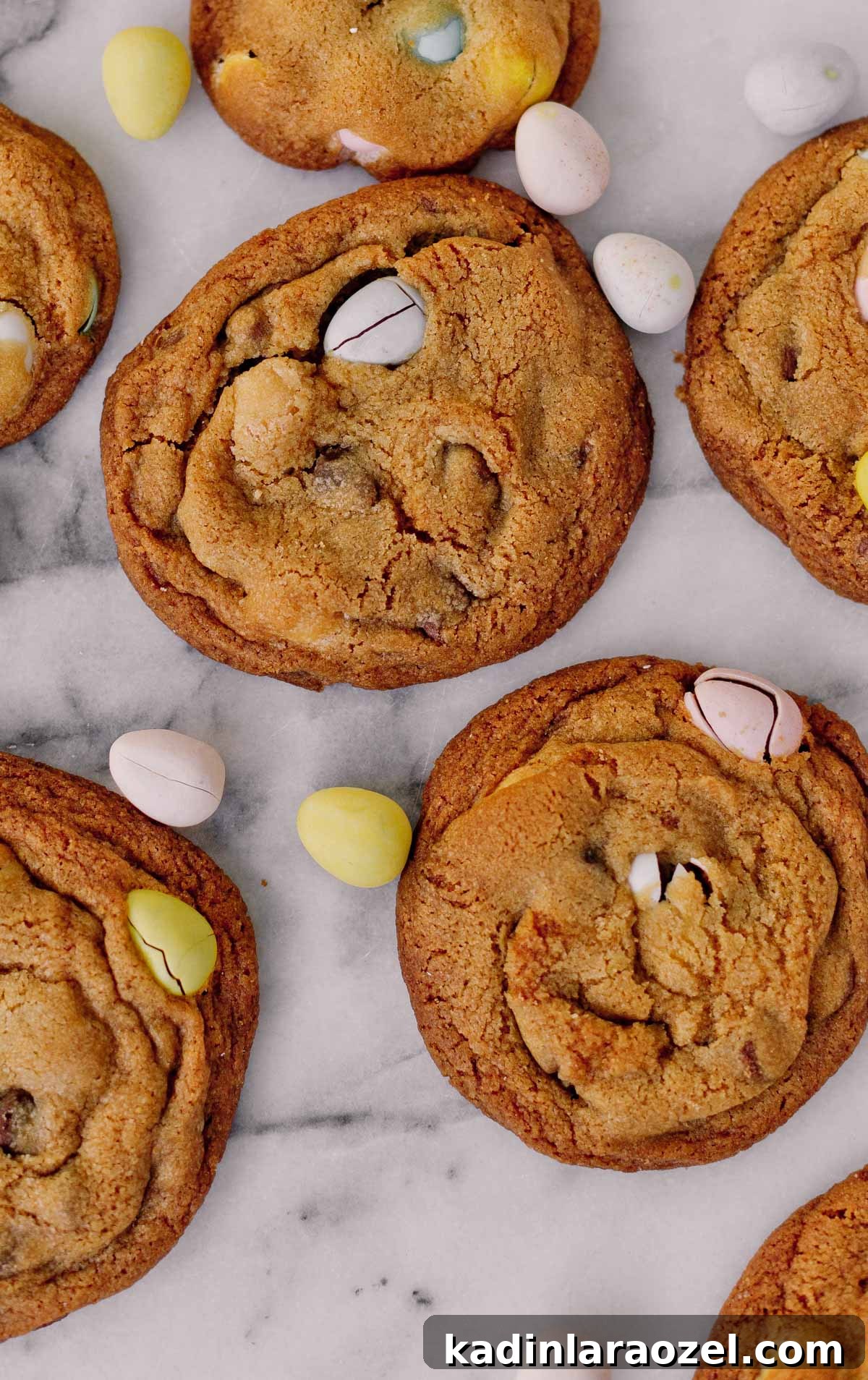 Cadbury Chocolate Chip Cookie Recipe — Chewy, Chocolatey Treats 4 closeup details of cookies on marble slab with Cadbury candy surrounding it