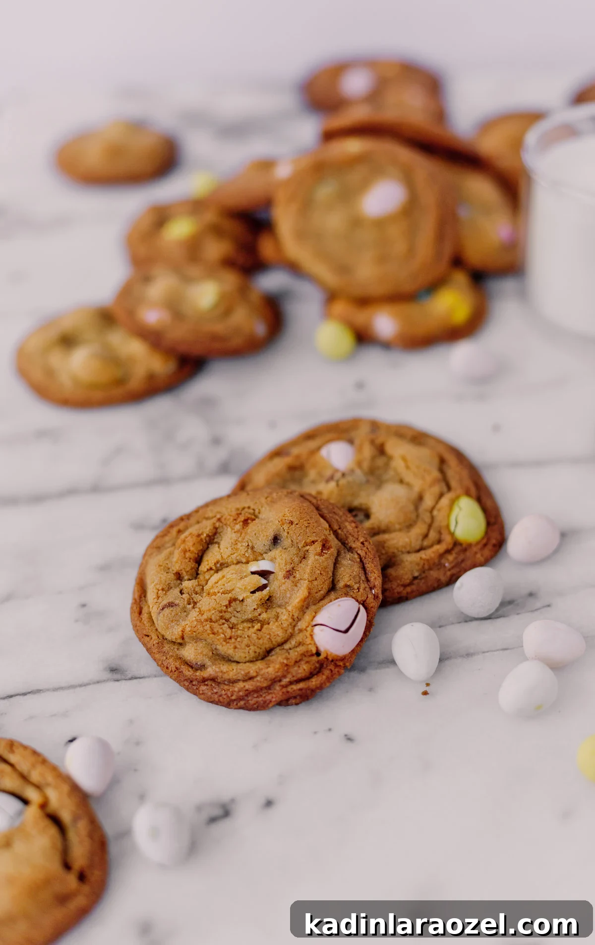 Cadbury Chocolate Chip Cookie Recipe — Chewy, Chocolatey Treats 8 Cadbury Choc Chip Cookies on marble with easter candy all around