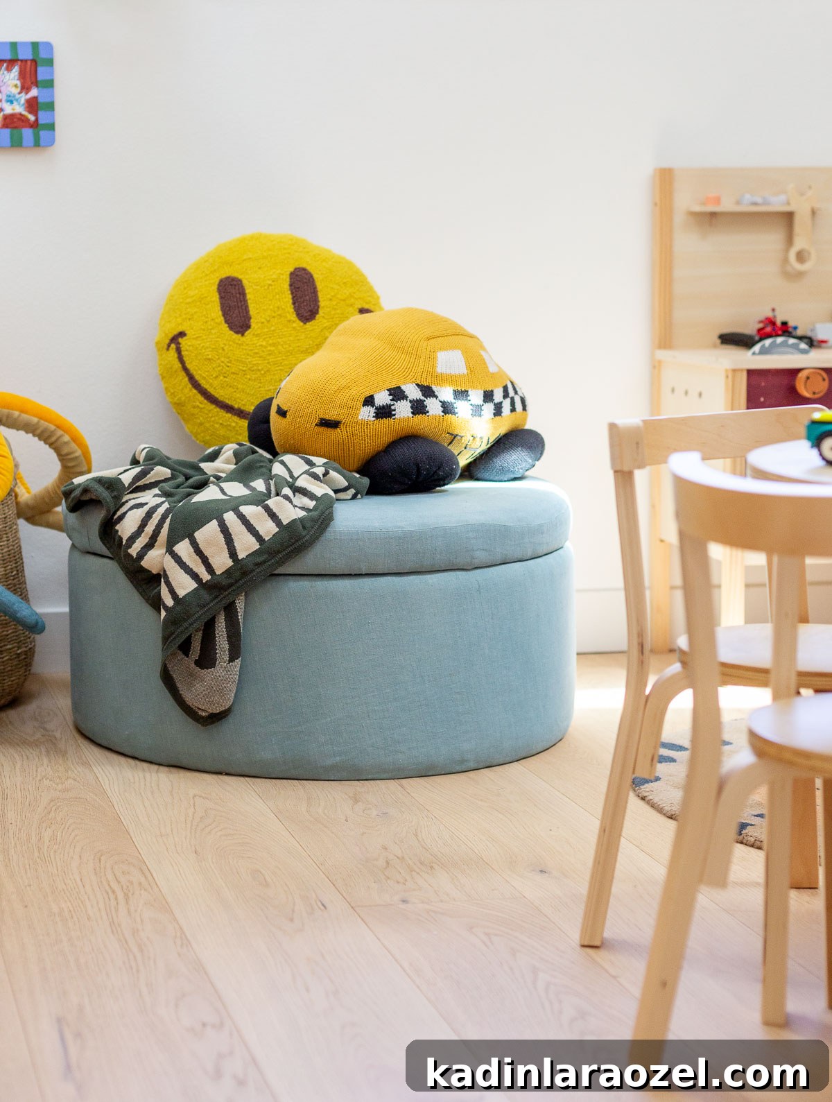 kids room with blue ottoman and colorful pillows and toys