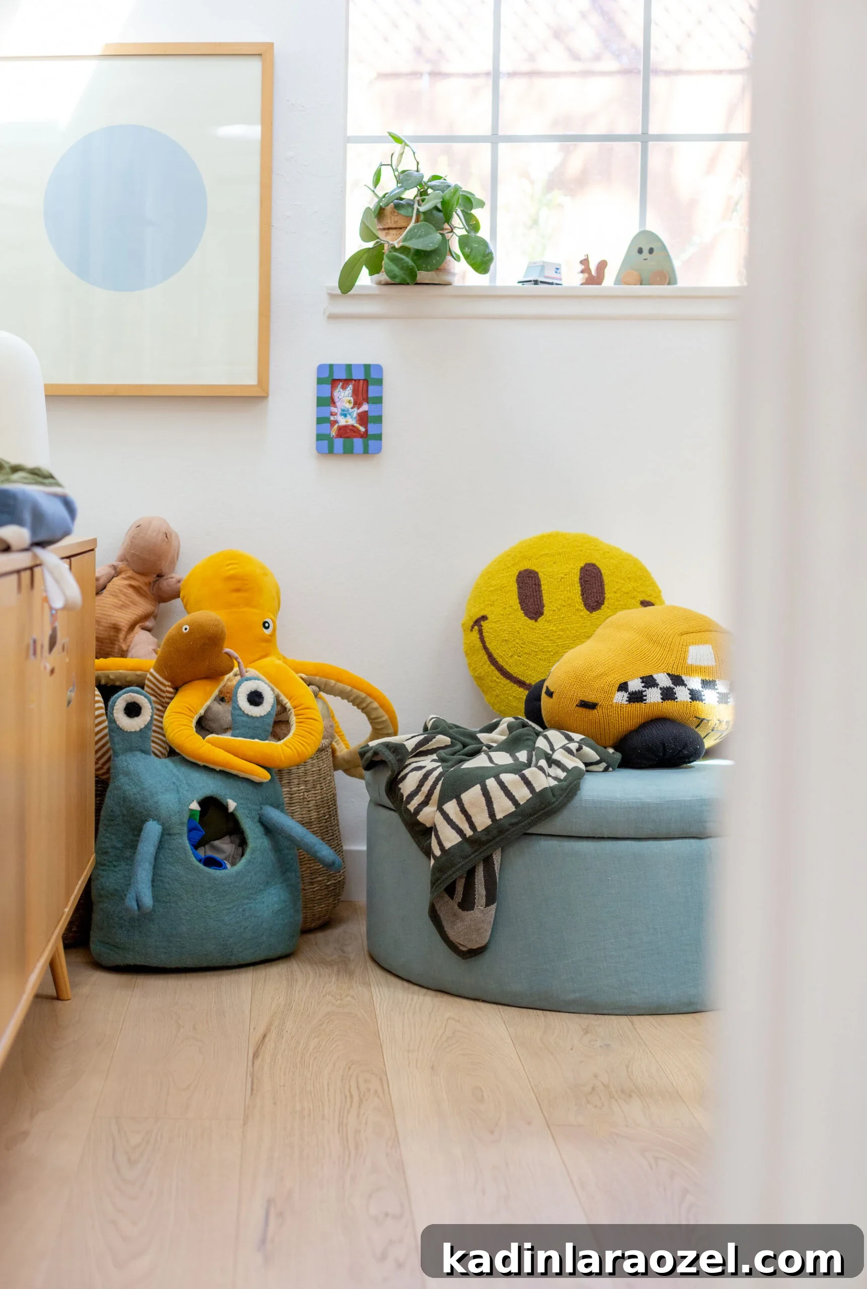 white bright kids room with colorful toys and blue round ottoman