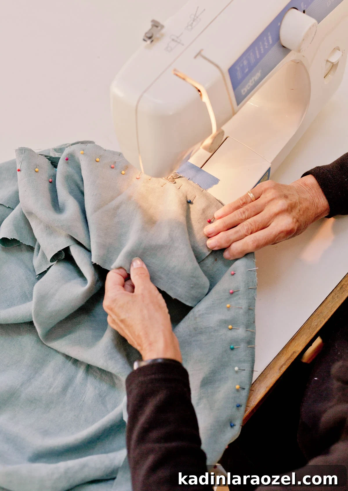 sewing blue fabric with lots of straight pins