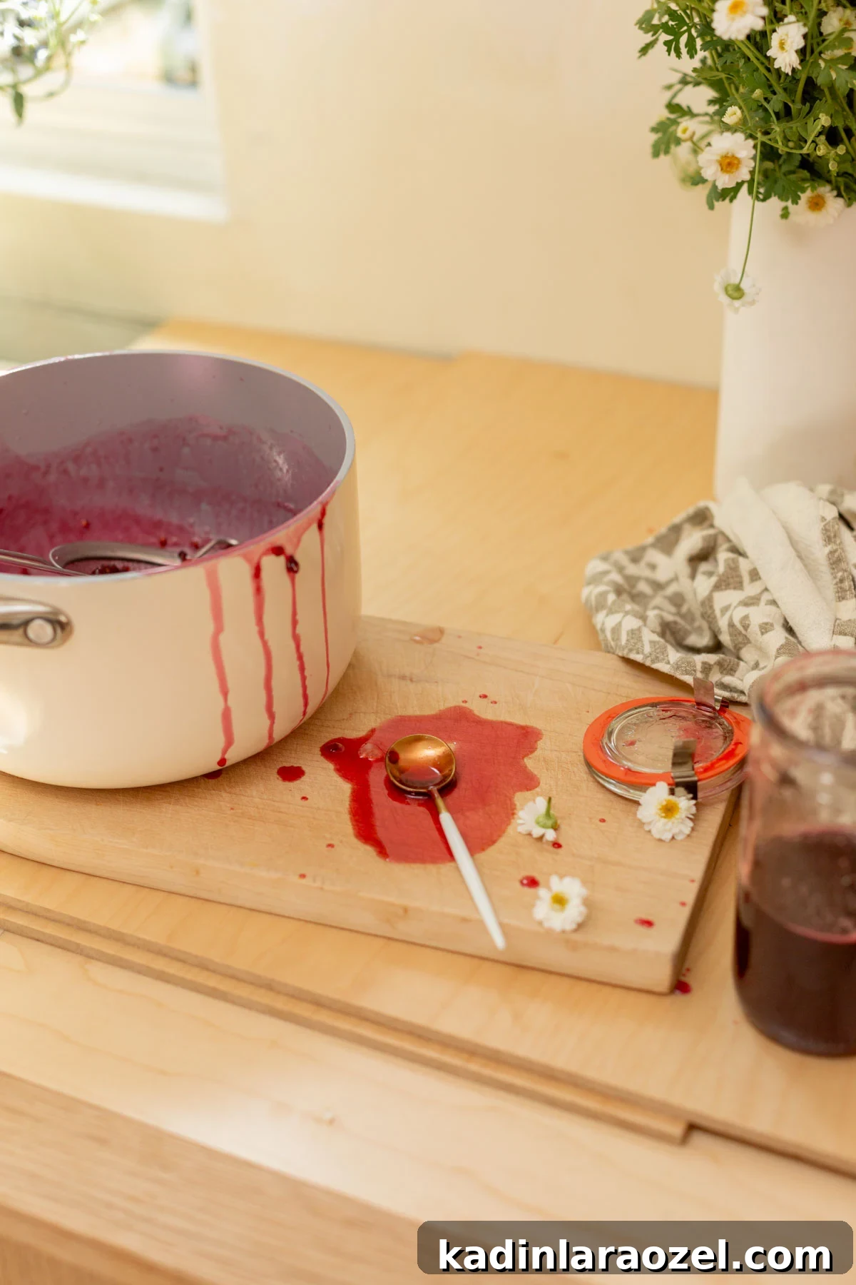 Three-Ingredient Blackberry Syrup Recipe for Pancakes and Desserts 3 messy kitchen pans with blackberry sauce spilled on the kitchen counter