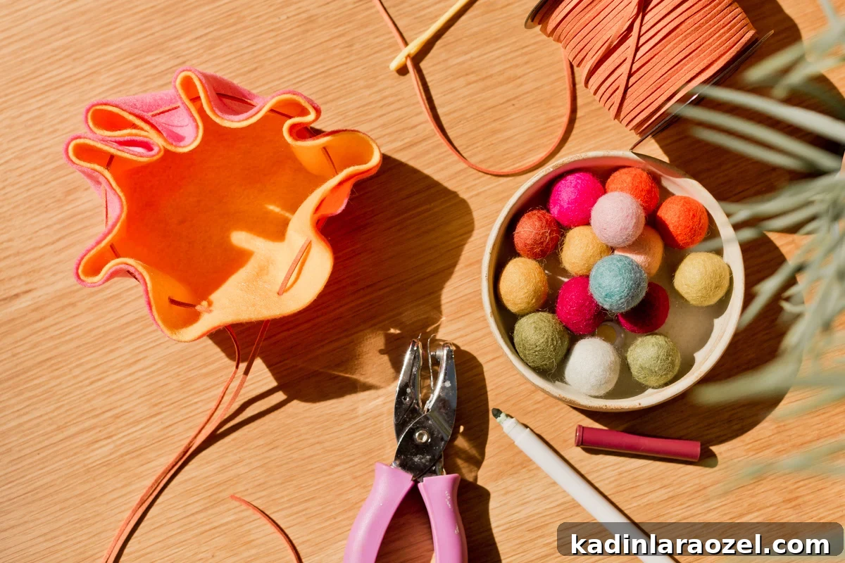 DIY Drawstring Pouch: Step-by-Step Sewing Tutorial 7 felt pouch being made, with a hole punch and felt balls