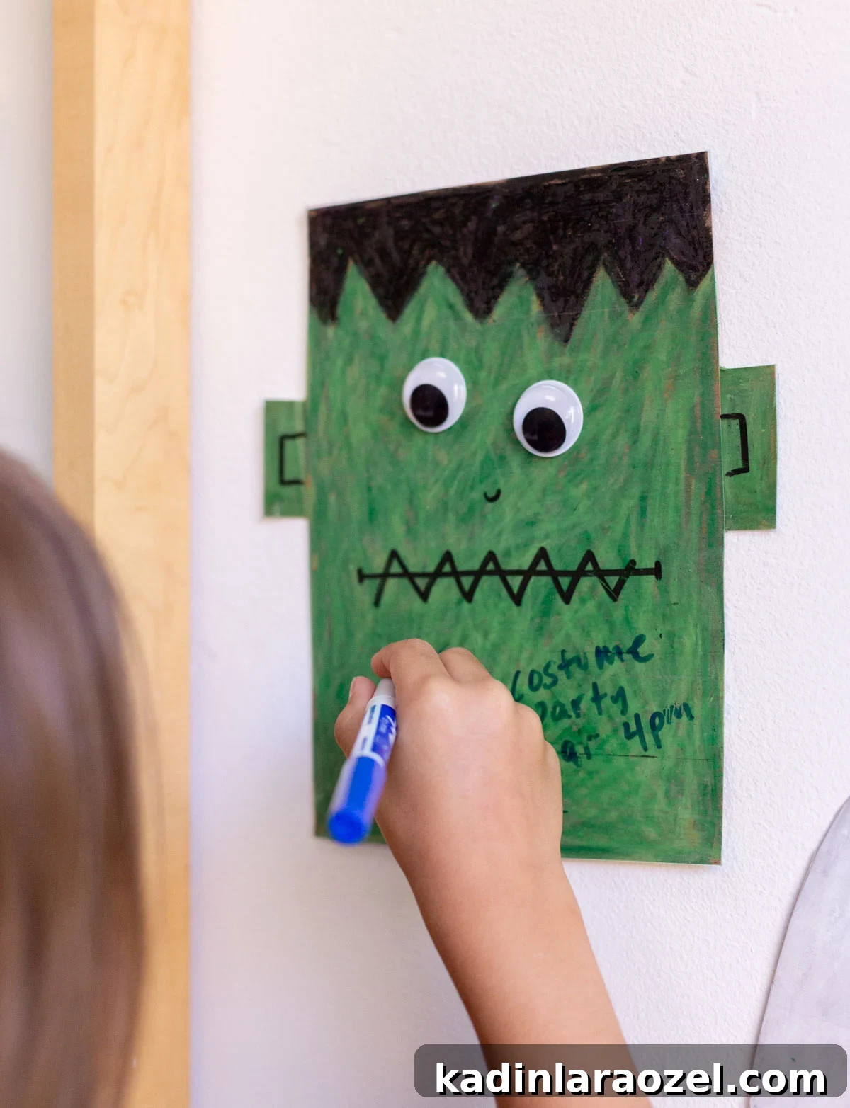 child drawing on halloween dry erase board