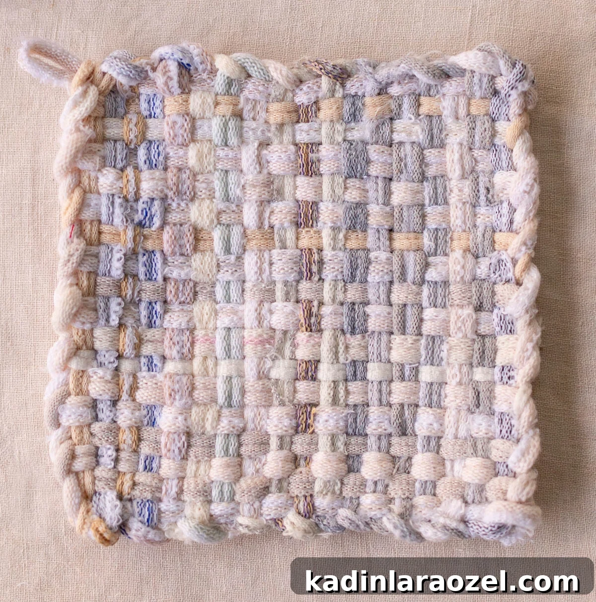 completed potholder in neutral grey and blues
