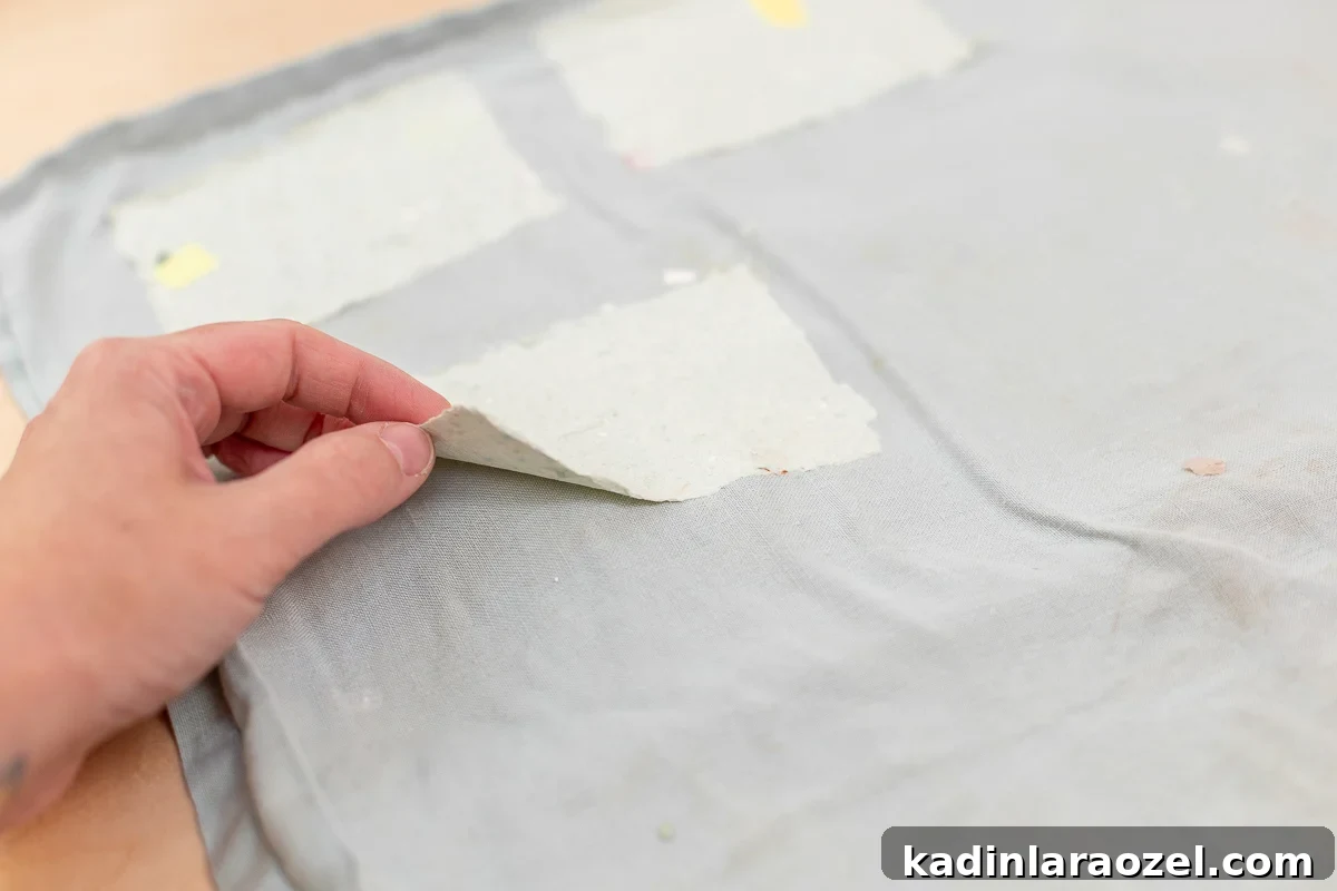 peeling homemade paper from towel after its dry and ready to use