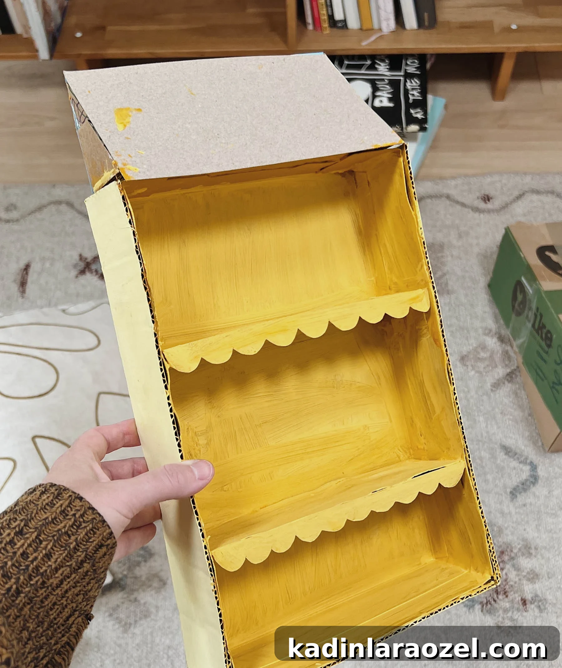 DIY Cardboard Dollhouse Made from a Cereal Box 5 painting cardboard to make a dollhouse with shelves for a kids room