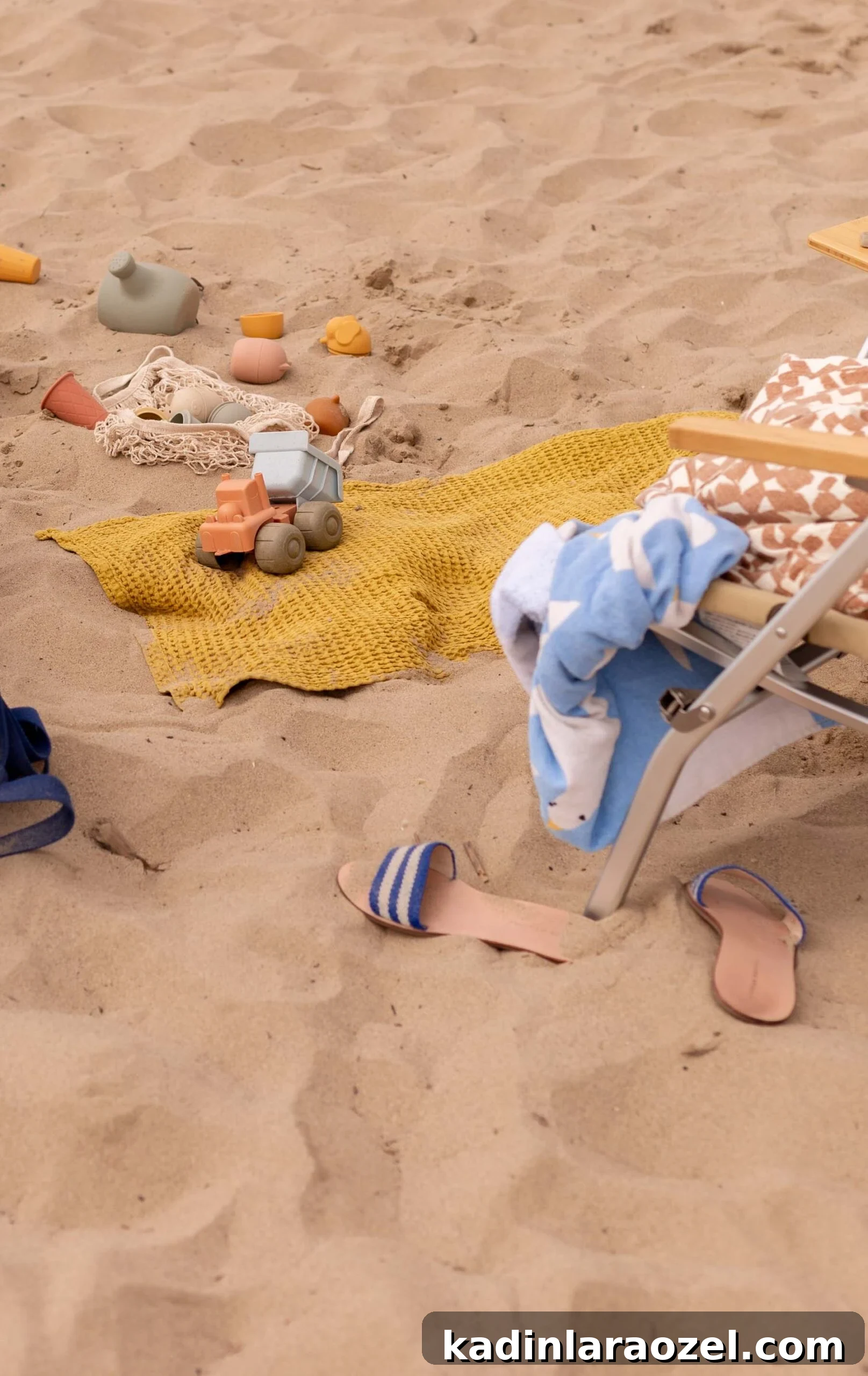 17 Fun Beach Activities for Kids and Families 3 beach setup with women's sandals and kids neutral beach toys