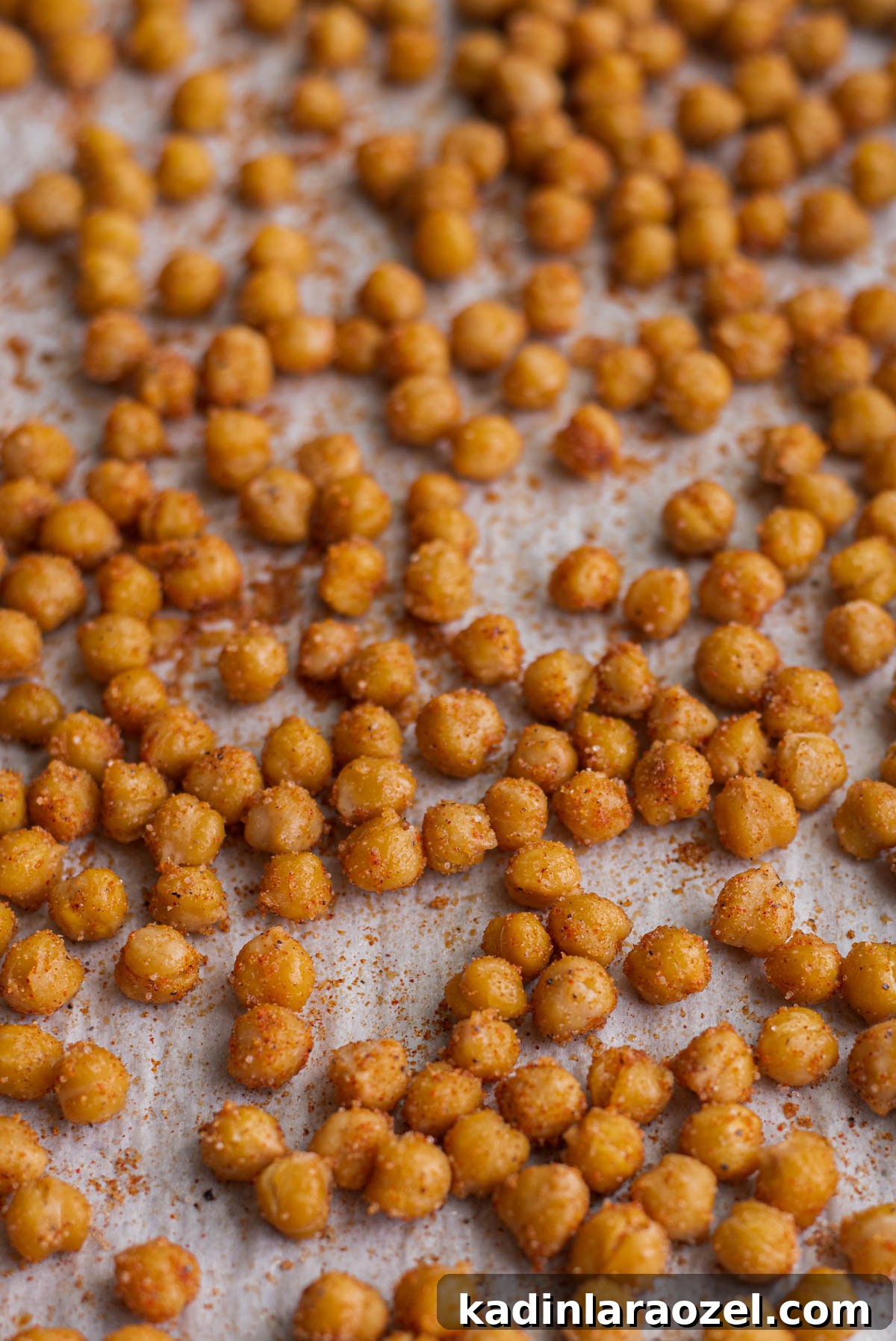 Crispy Roasted Chickpeas Recipe for Snack or Salad Topping 8 crispy roasted chickpeas straight from the oven, on a baking sheet with seasoning