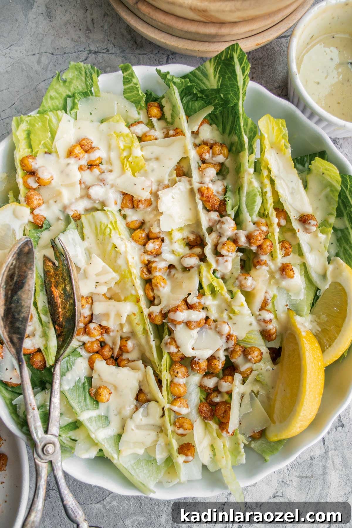 Drizzled dressing on top of crispy chickpeas and romaine lettuce