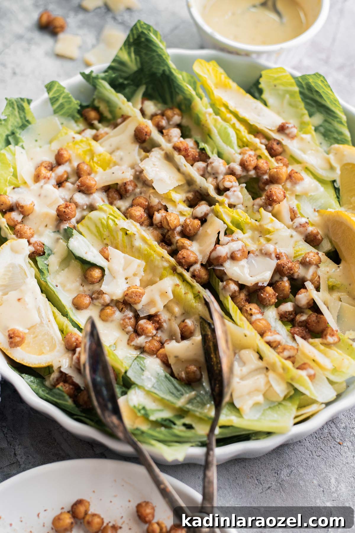 roasted chickpea salad with serving tongs