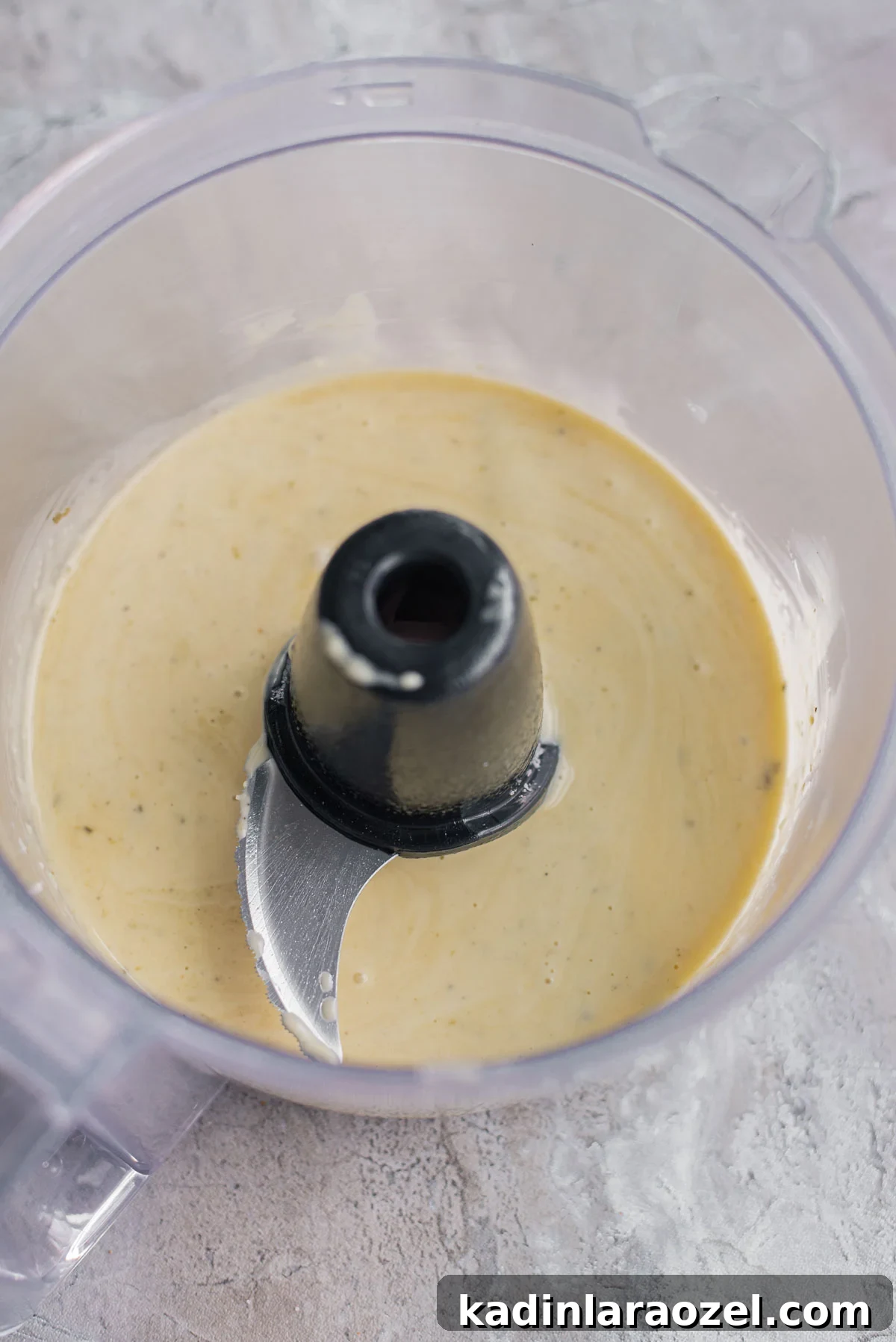 homemade dressing being blended in a food processor
