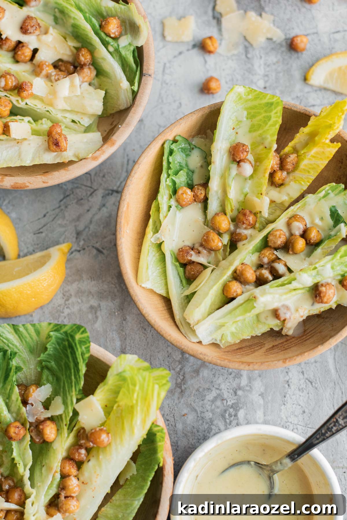 romaine lettuce and roasted chickpeas salad in small bowls with lemon slices