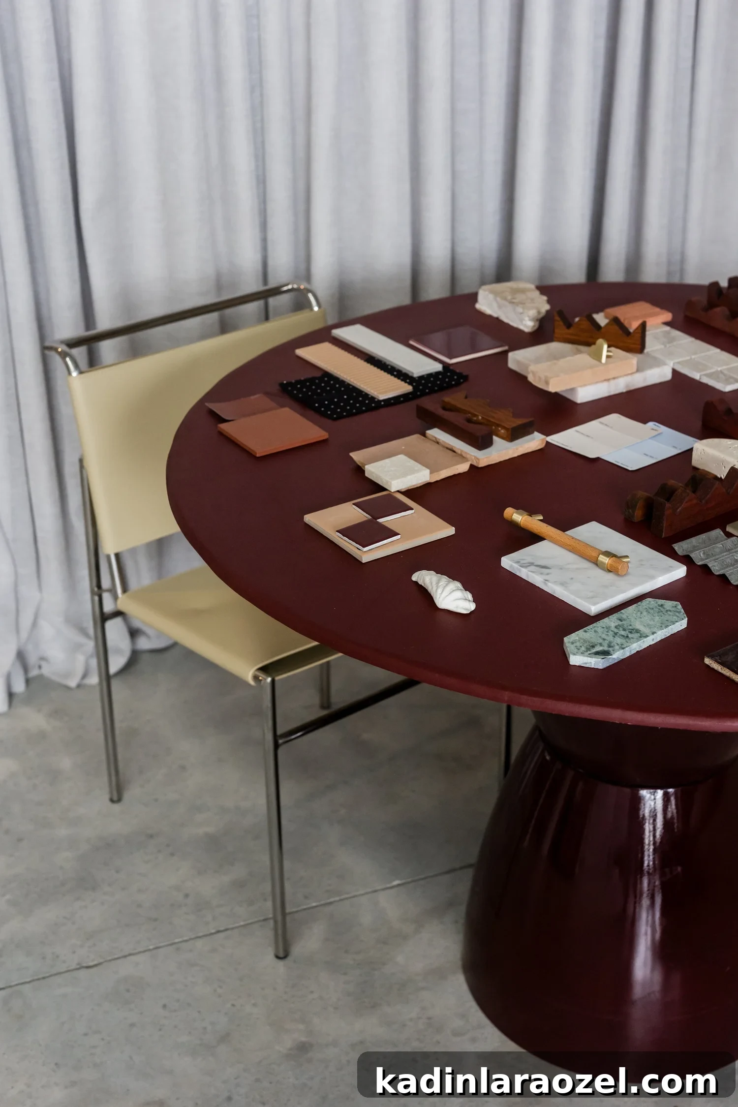 dark burgundy dining table in minimal modern dining room with papers and office supplies on it