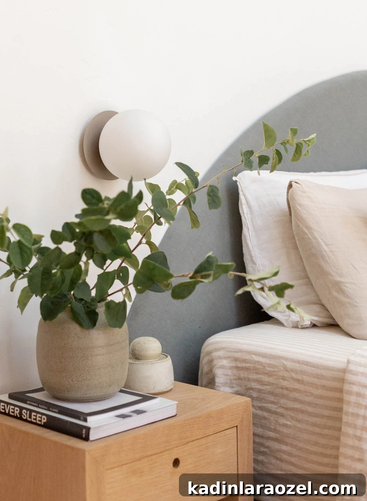 minimal organic modern bedroom with simple modern sconce light and half circle headboard