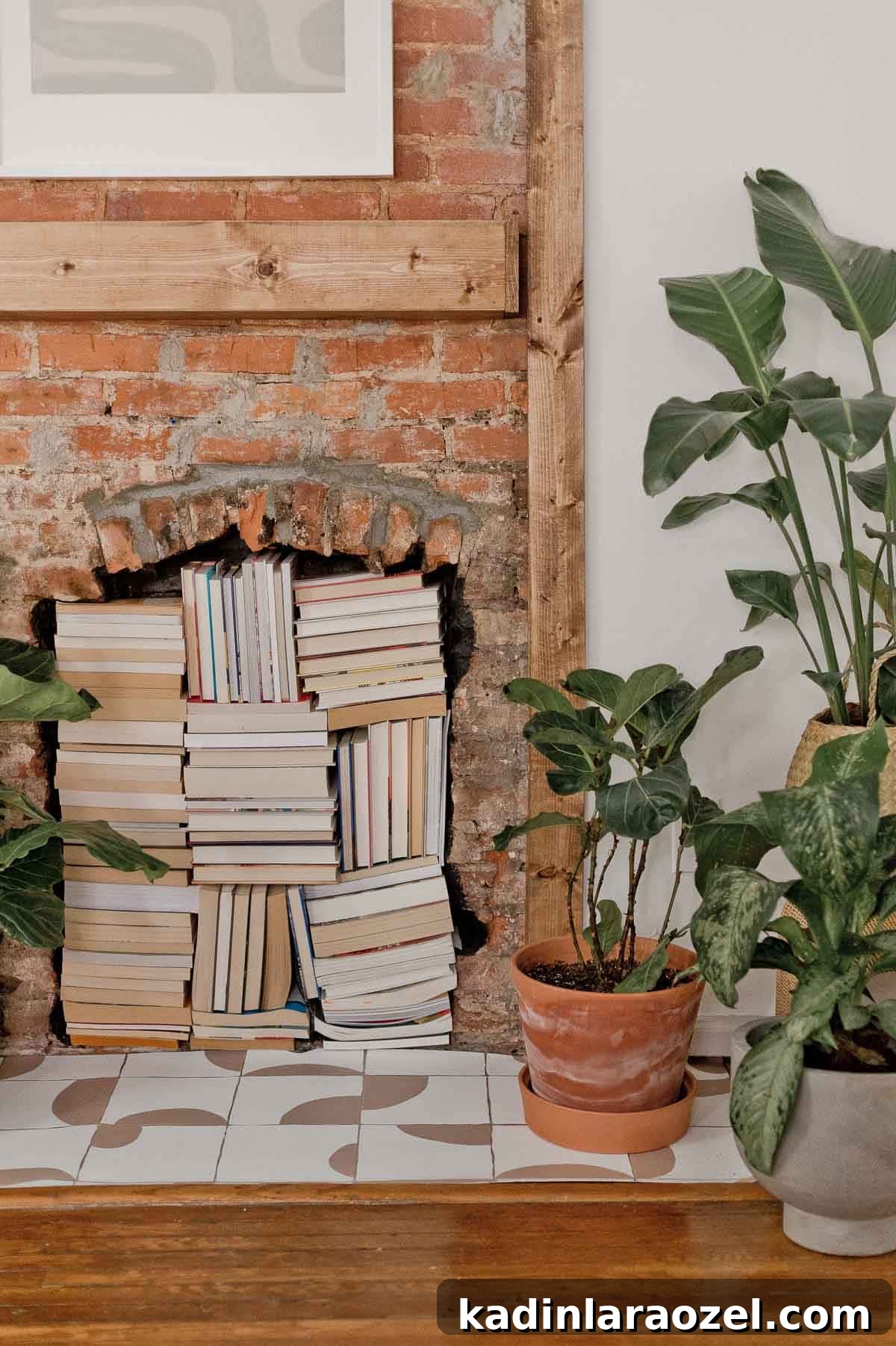 books stacked all the way up in a non-working fireplace with brick hearth and plants surrounding it