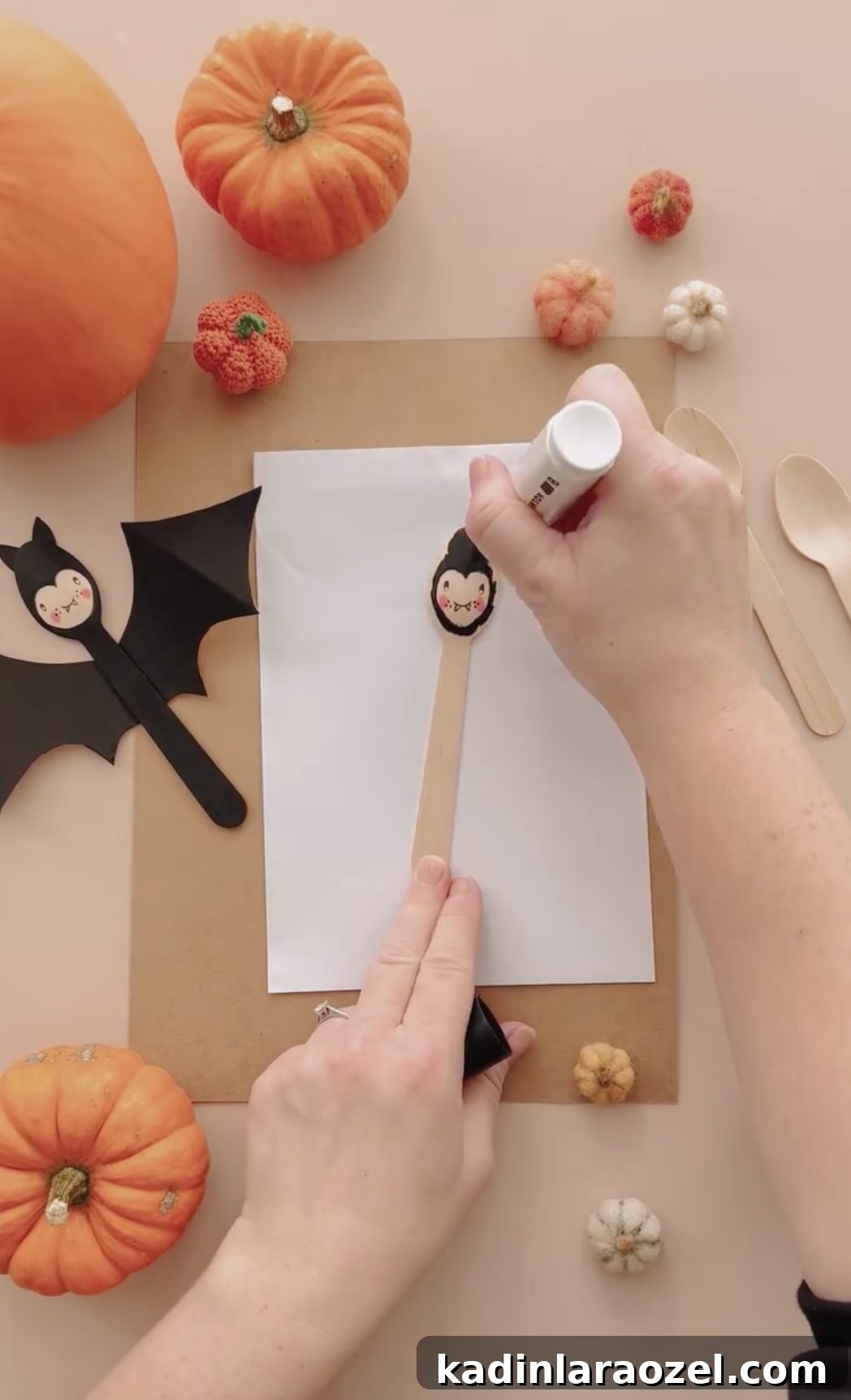 making a craft with a wooden spoon to paint it as a cute black bat for halloween