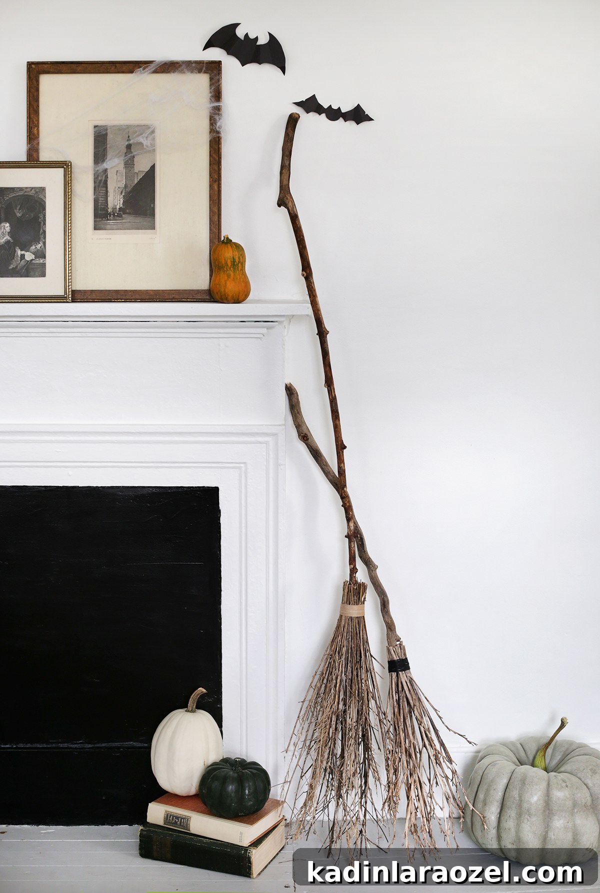 2 DIY brooms leaning against a fireplace fro Halloween