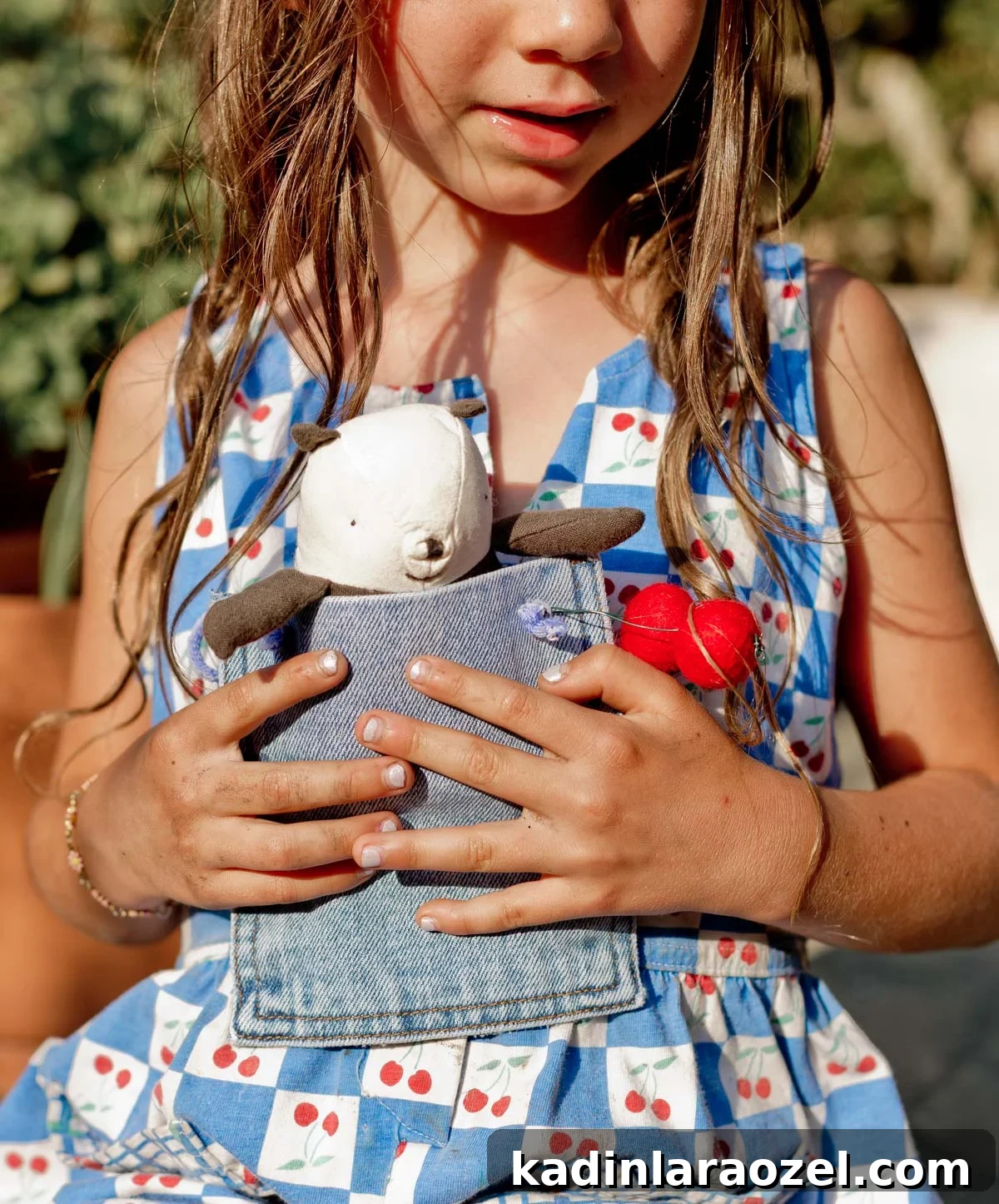 DIY No-Sew Kids' Purse from Old Jeans 13 girl holding a denim purse pouch with a small stuffed panda inside