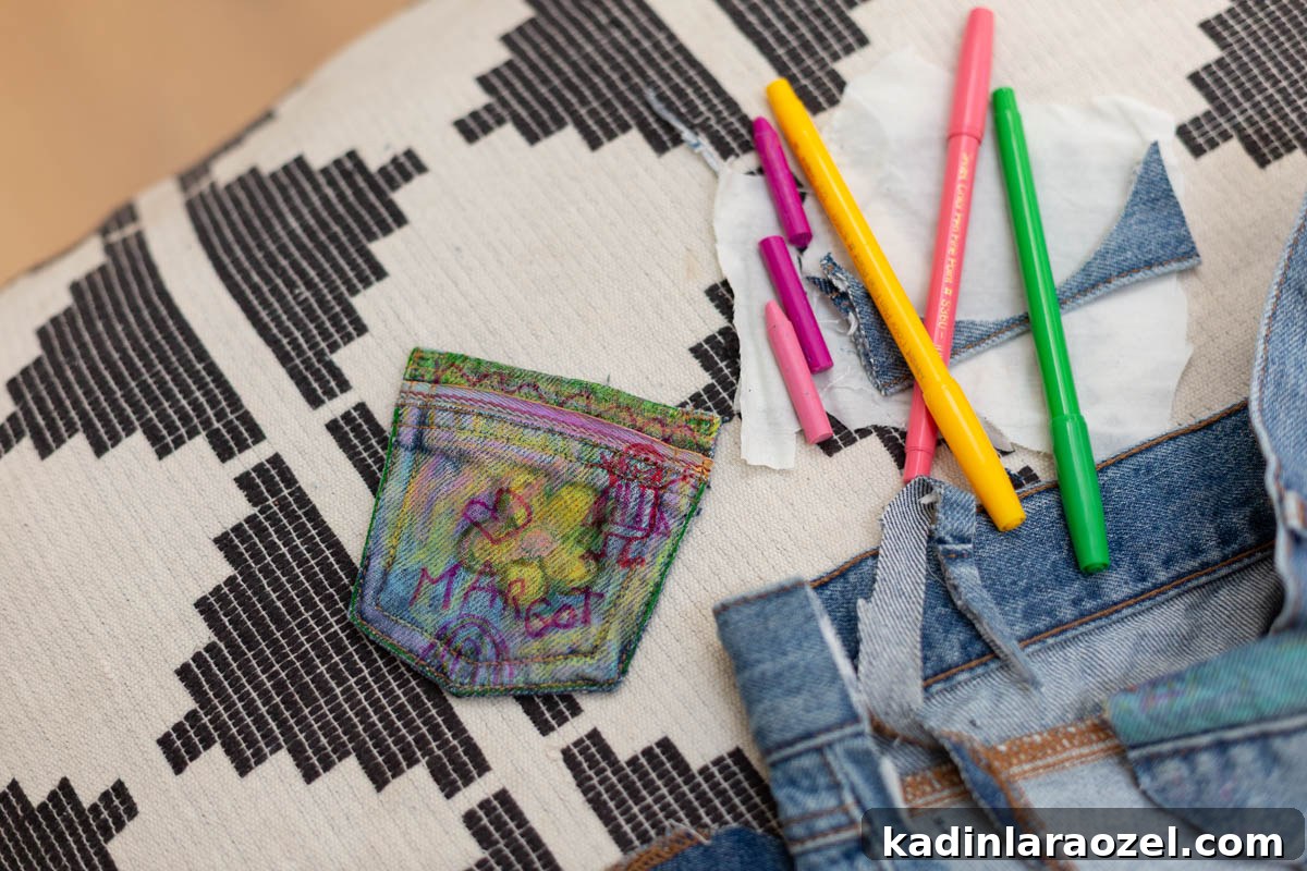 DIY No-Sew Kids' Purse from Old Jeans 8 small denim pouch with kids doodles drawn onto it, with markers