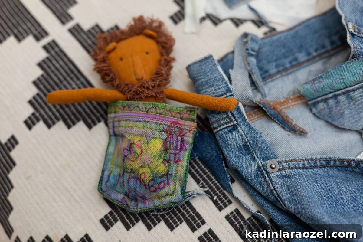 DIY No-Sew Kids' Purse from Old Jeans 9 small denim pouch with kids doodles and a small stuffed lion inside