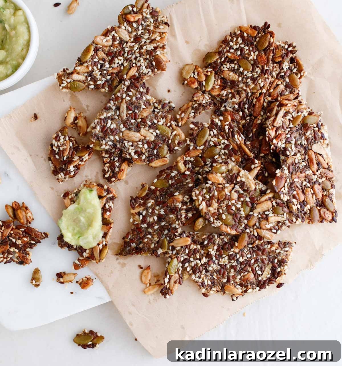 Crispy Seed Crackers Recipe: Homemade Savory Snack 15 seed crackers on a cracker board with dips