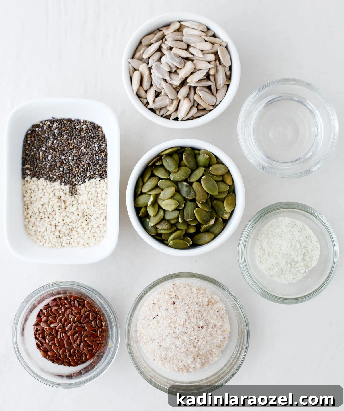 Crispy Seed Crackers Recipe: Homemade Savory Snack 4 ingredients for making homemade seed crackers, each ingredient is in a different bowl