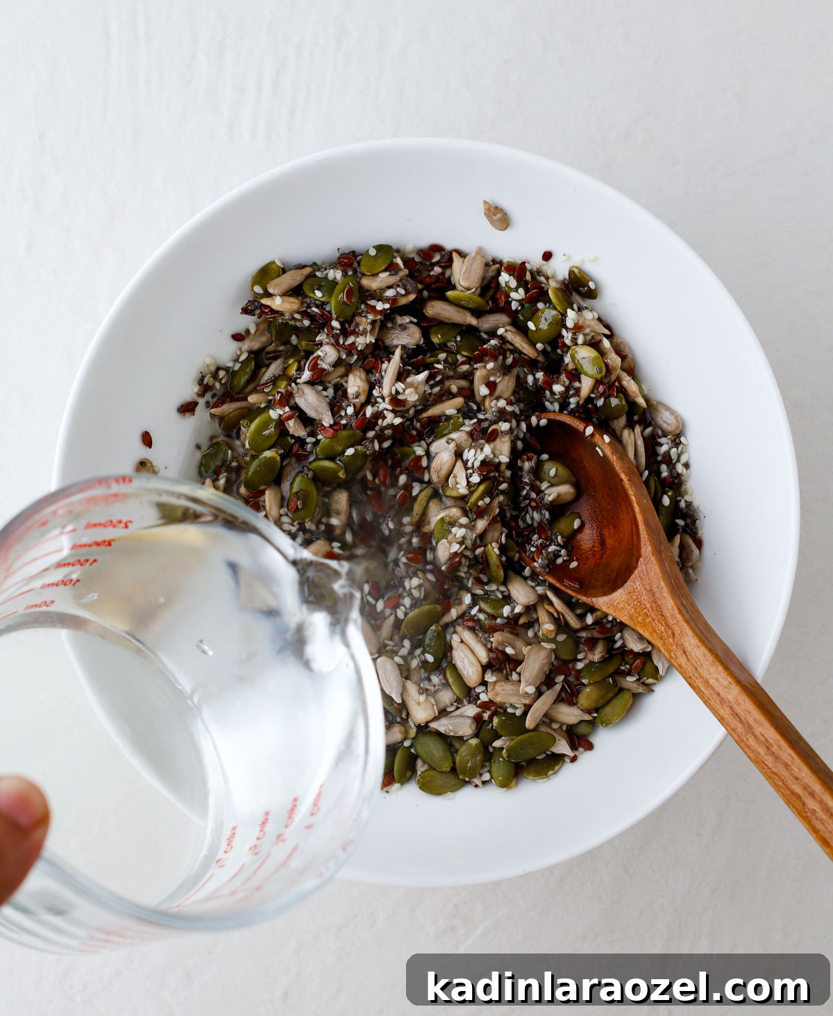 Crispy Seed Crackers Recipe: Homemade Savory Snack 6 mixing seeds and other seed cracker ingredients in a bowl