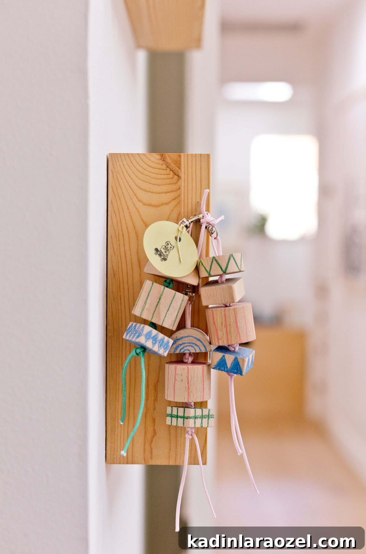 group of wood keychains hanging from a shelf 