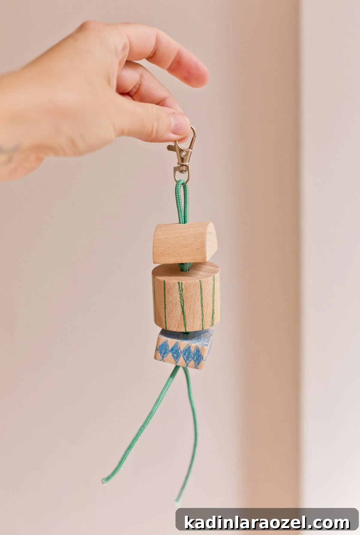 simple chunky wood keychain being held by woman's hand
