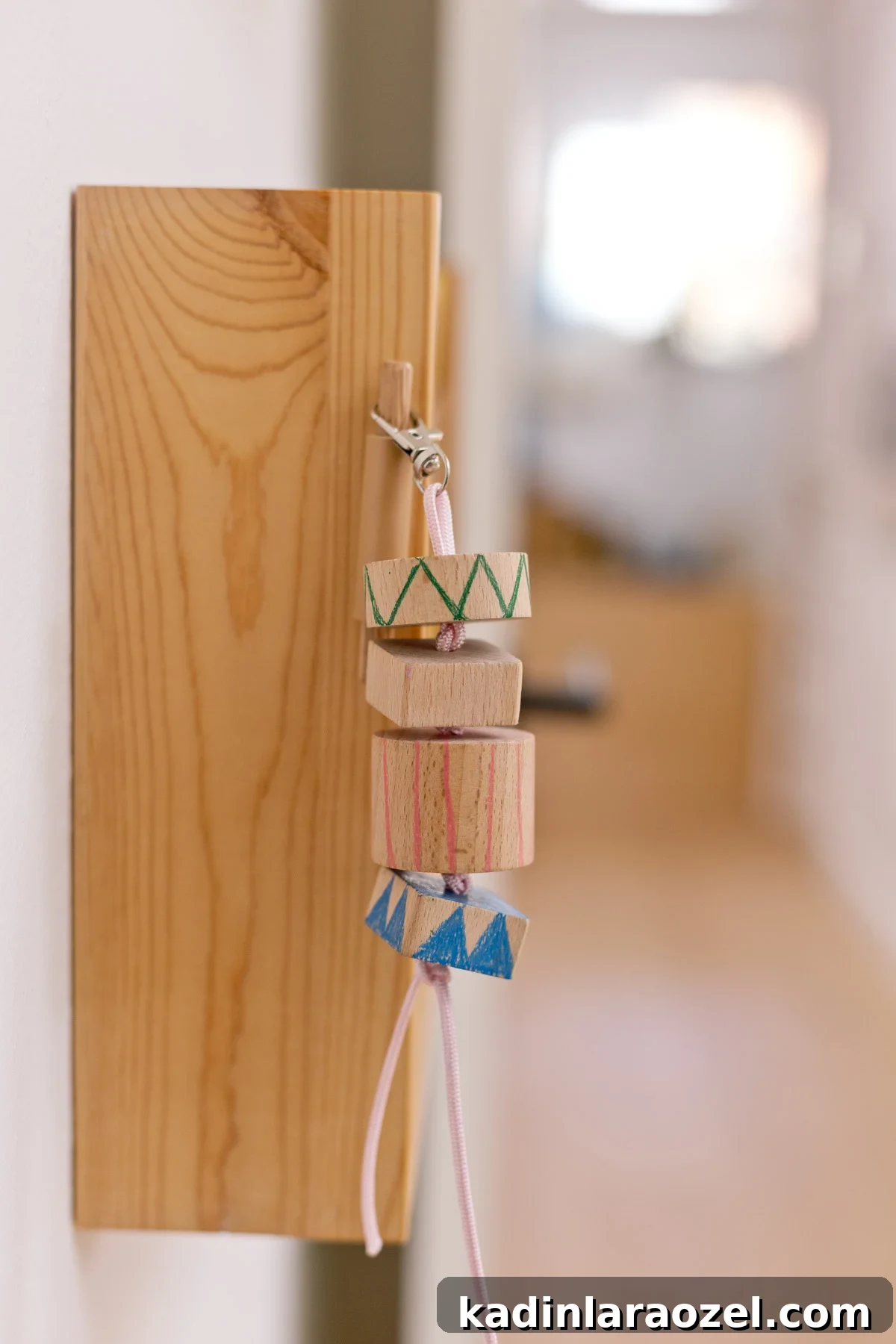 wood keychain hanging from wood shelf in a bedroom