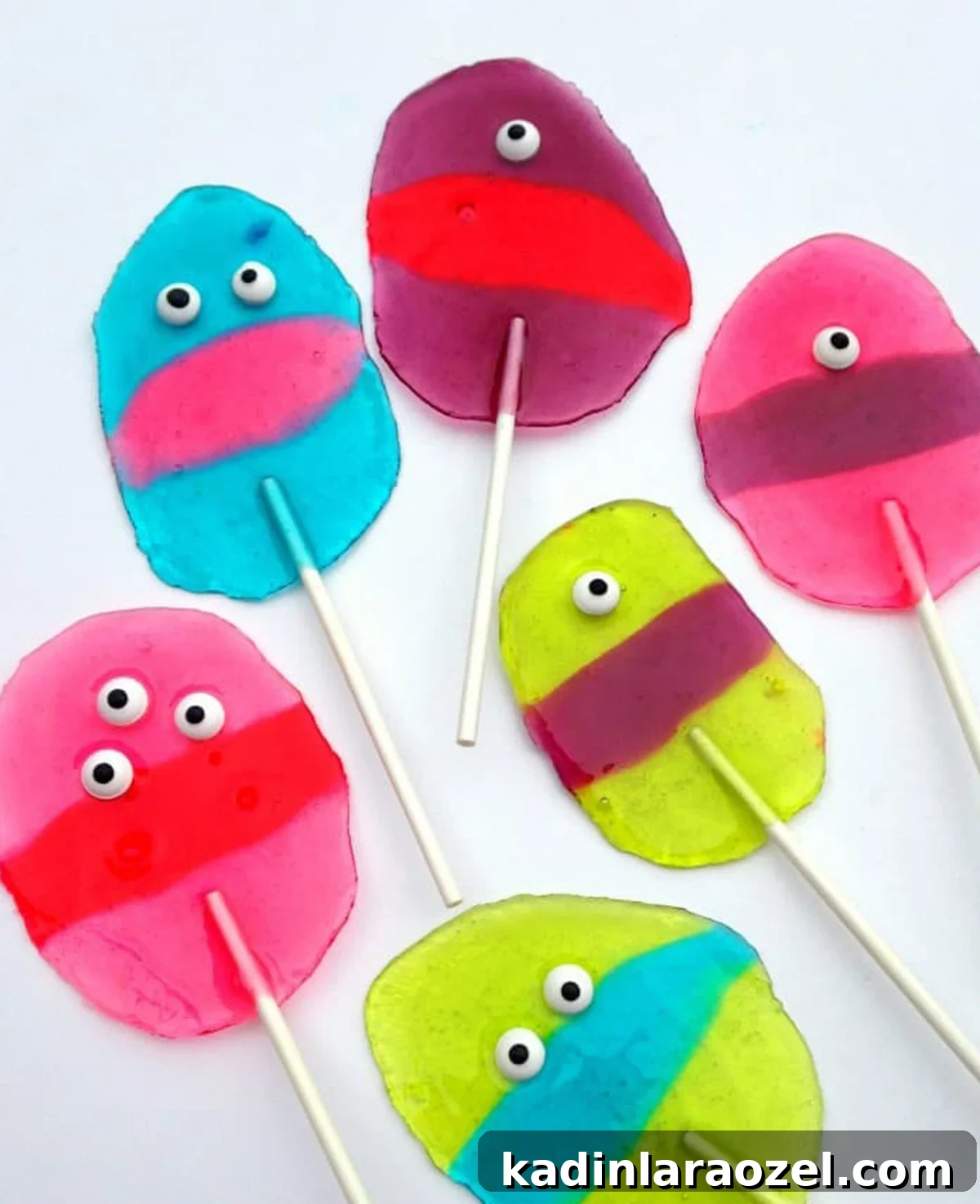 27 Spooky Halloween Desserts to Delight Your Guests 12 homamde halloween lollipops that look like colorful, cute monsters