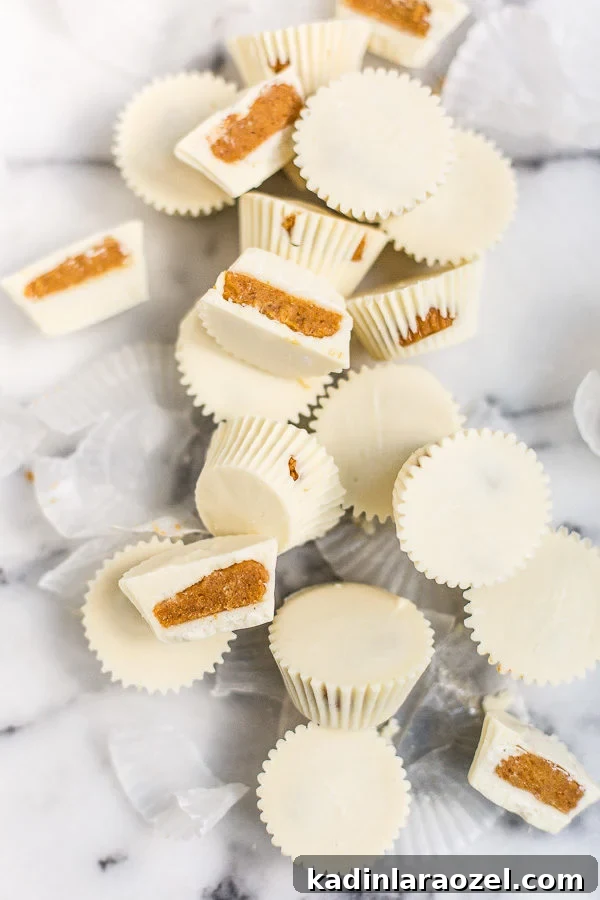 27 Spooky Halloween Desserts to Delight Your Guests 14 Homemade pumpkin pie candy cups on a marble countertop, all scattered in a pile