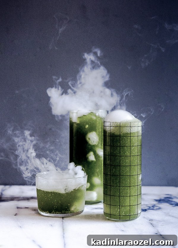 27 Spooky Halloween Desserts to Delight Your Guests 15 green halloween cocktail with spooky dry ice mist coming off the top of the glasses