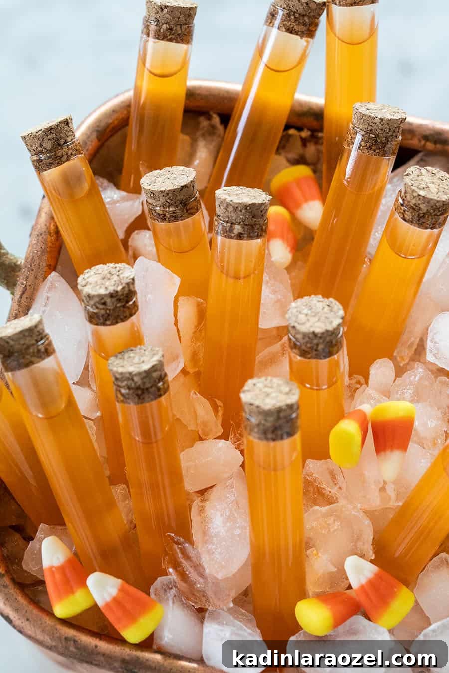 27 Spooky Halloween Desserts to Delight Your Guests 18 halloween cocktails in an ice tub with candy corns all around it