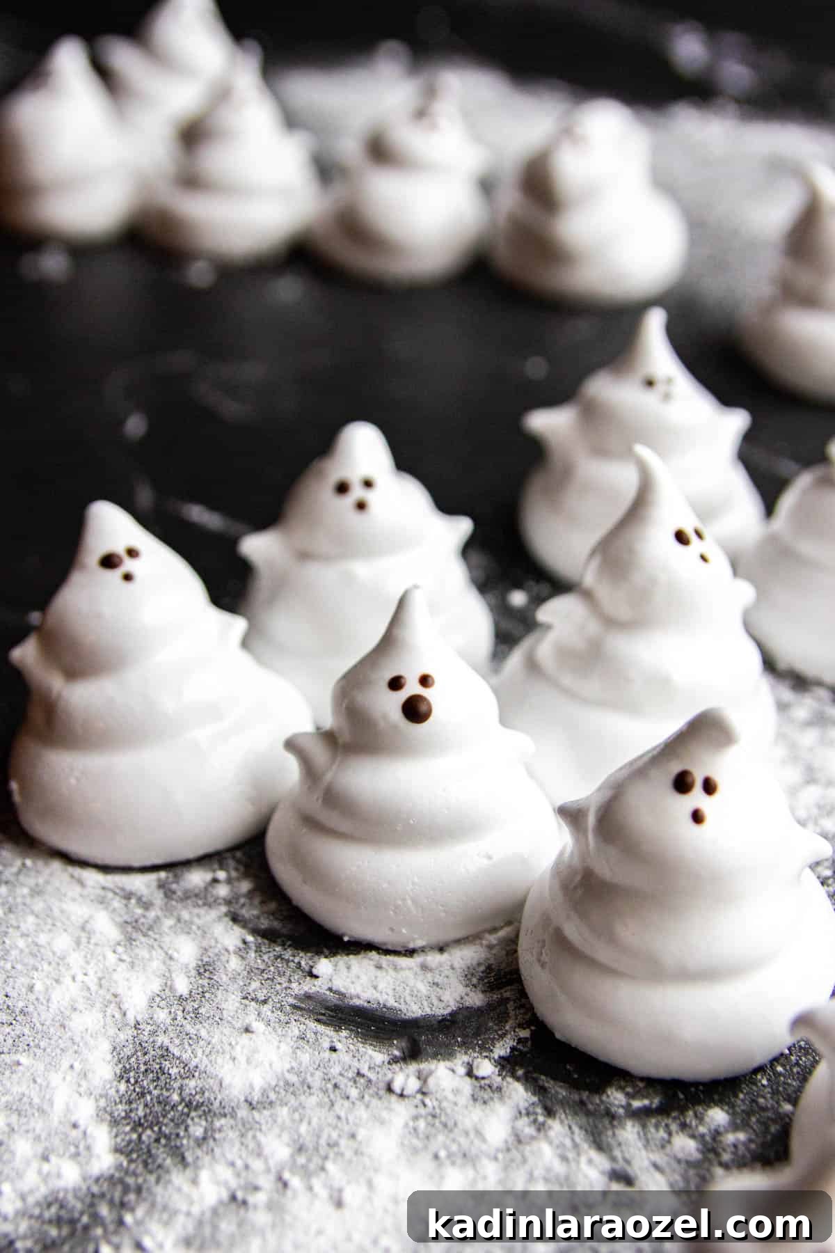 27 Spooky Halloween Desserts to Delight Your Guests 20 marshmallow halloween treats that look like ghosts with tiny chocolate faces