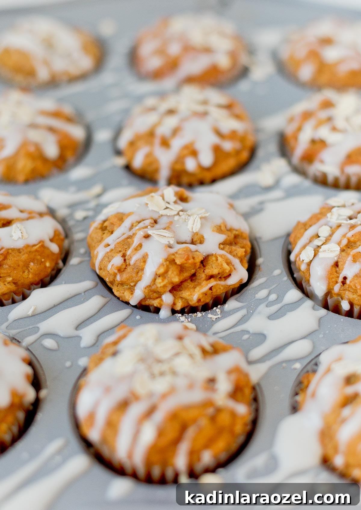 27 Spooky Halloween Desserts to Delight Your Guests 23 pumpkin muffins with icing drizzled on top with oats