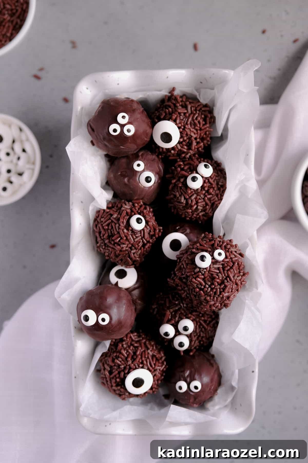 27 Spooky Halloween Desserts to Delight Your Guests 27 small round brownie bites for halloween with sprinkles and candy googly eyes