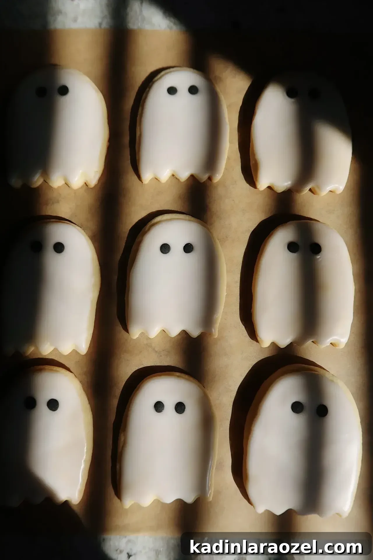 27 Spooky Halloween Desserts to Delight Your Guests 5 minimal ghost cookies in a shadowy kitchen