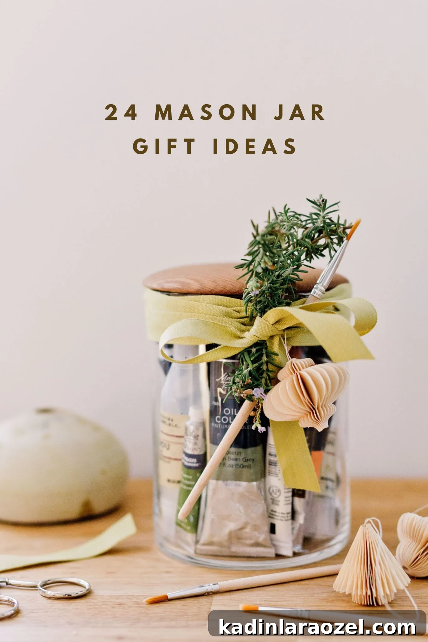 glass mason jar filled with art supplies and paint brushes for a creative holiday gift