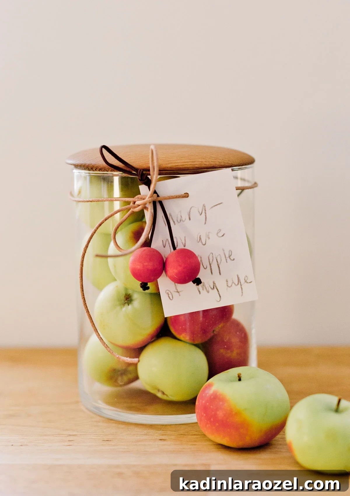 tiny apples, all in a glass jar with a handwritten note as a gift for the holidays